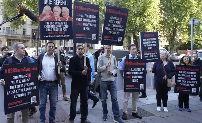 A small number of protesters wait for Huw Edwards an ex-BBC news presenter to arrive at Westminster Magistrate's Court for sentencing after he pleaded guilty to three counts of making indecent images of children in London, Monday, Sept. 16, 2024. (AP Photo/Frank Augstein)