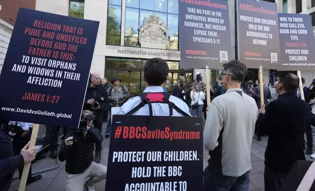 A small number of protesters wait for Huw Edwards an ex-BBC news presenter to arrive at Westminster Magistrate's Court for sentencing after he pleaded guilty to three counts of making indecent images of children in London, Monday, Sept. 16, 2024. (AP Photo/Frank Augstein)