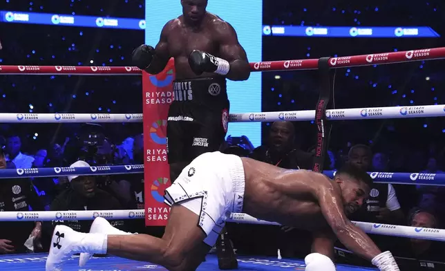 Daniel Dubois, left, knocks out Anthony Joshua in the IBF World Heavyweight bout at Wembley Stadium, in London, Saturday, Sept. 21, 2024. (Bradley Collyer/PA via AP)