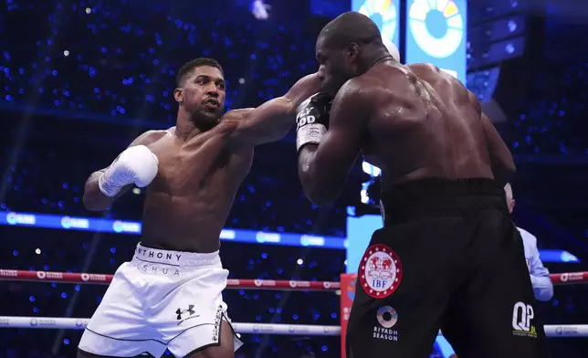 Anthony Joshua, left, and Daniel Dubois fight in the IBF World Heavyweight bout at Wembley Stadium, in London, Saturday, Sept. 21, 2024. (Bradley Collyer/PA via AP)