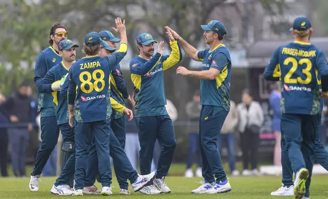 Australia's players celebrate taking the wicket of Scotland's George Munsey during the third T20 International test match between Scotland and Australia in Edinburgh, Scotland, Saturday, Sept. 7, 2024. (Malcolm Mackenzie/PA via AP)