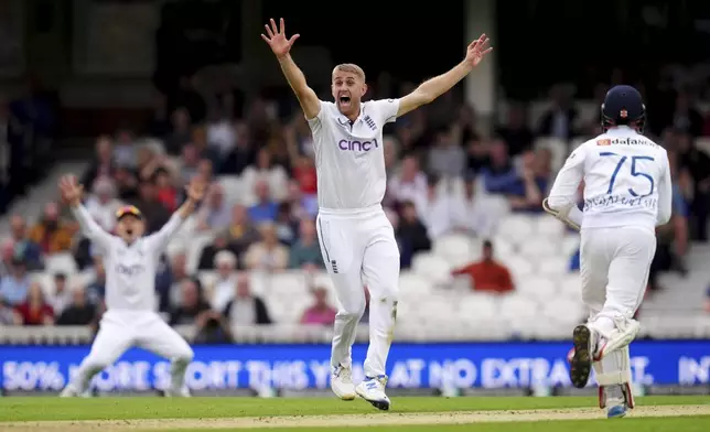 England's Olly Stone celebrates taking the wicket of Sri Lanka's Dinesh Chandimal during day two of the Third Rothesay Men's Test match between England and Sri Lanka in London, England, Saturday, Sept. 7, 2024. (John Walton/PA via AP)