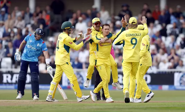 Australia's Marnus Labuschagne celebrates with team-mates including Travis Head, on his back, after taking the wicket of England's Harry Brook during the first one day international match at Trent Bridge, Nottingham, England, Thursday, Sept. 19, 2024. (Nigel French/PA via AP)