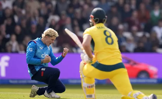 England's Jacob Bethell celebrates taking the wicket of Australia's Mitchell Marsh during the second One Day international match between England and Australia at Headingley, Leeds, Saturday Sept. 21, 2024. (Danny Lawson/PA via AP)