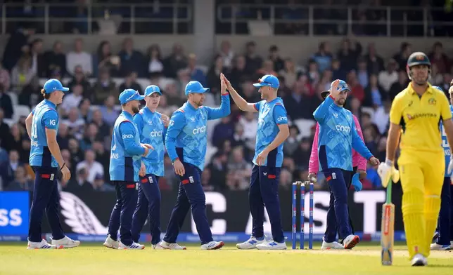 England's Liam Livingstone, 4th left, celebrates with teammates after taking the catch to dismiss Australia's Marnus Labuschagne during the second One Day international match between England and Australia at Headingley, Leeds, Saturday Sept. 21, 2024. (Danny Lawson/PA via AP)