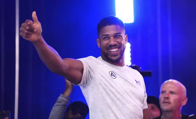 Boxer Anthony Joshua gestures during the weigh-in at Trafalgar Square in London, Friday, Sept. 20, 2024, for their upcoming IBF heavyweight title fight agains Daniel Dubois. (Bradley Collyer/PA via AP)