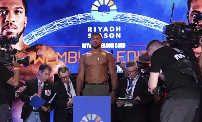 Boxer Anthony Joshua stands on the scale during the weigh-in at Trafalgar Square in London, Friday, Sept. 20, 2024, for his upcoming IBF heavyweight title fight against Daniel Dubois. (Bradley Collyer/PA via AP)