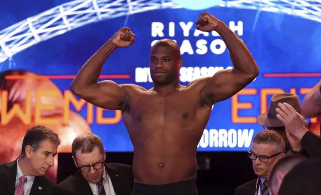 Boxer Daniel Dubois stands on the scale during the weigh-in at Trafalgar Square in London, Friday, Sept. 20, 2024, for his upcoming IBF heavyweight title fight against Anthony Joshua. (Bradley Collyer/PA via AP)