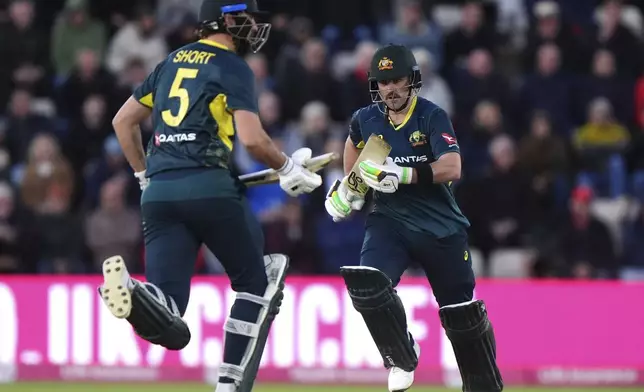 Australia's Matt Short, left, and Josh Inglis runs between the wickets during the first IT20 match between England and Australia at the Utilita Bowl, Southampton, England, Wednesday, Sept. 11, 2024. (Bradley Collyer/PA via AP)