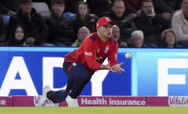 England's Sam Curran catches out Australia's Matt Short during the first IT20 cricket match at the Utilita Bowl in Southampton, England, Wednesday, Sept. 11, 2024. (Bradley Collyer/PA via AP)