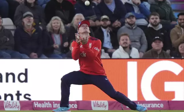 England's Jordan Cox catches out Australia's Travis Head during the first IT20 cricket match at the Utilita Bowl in Southampton, England, Wednesday, Sept. 11, 2024. (Bradley Collyer/PA via AP)