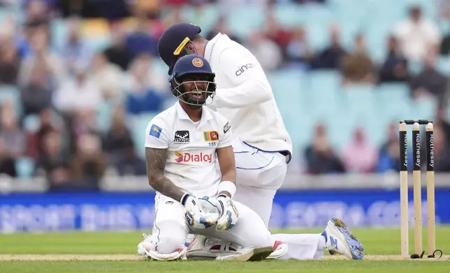 Sri Lanka's Pathum Nissanka reacts after diving to make up ground on day four of the Third Rothesay Men's Test at The Kia Oval, in London, Monday Sept. 9, 2024. (John Walton/PA via AP)