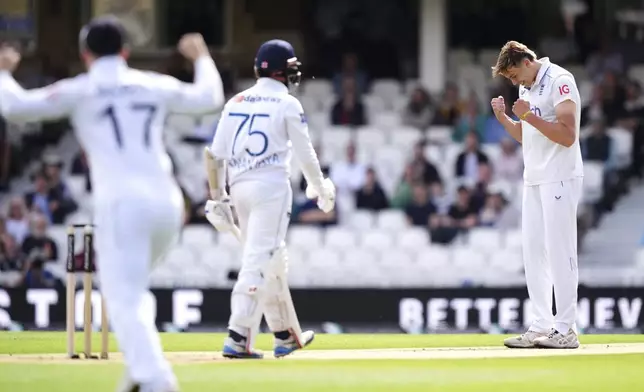 England's Josh Hull celebrates taking the wicket of Sri Lanka captain Dhananjaya de Silva, centre, during day three of the Third Rothesay Men's Test at The Kia Oval, London, Sunday Sept. 8, 2024. ( John Walton/PA via AP)