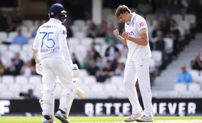 England's Josh Hull celebrates taking the wicket of Sri Lanka captain Dhananjaya de Silva, left, during day three of the Third Rothesay Men's Test at The Kia Oval, London, Sunday Sept. 8, 2024. ( John Walton/PA via AP)