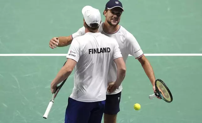 Finland's Otto Virtanen and Harri Heliovaara celebrate winning the Davis Cup group stage finals match against Britain's Dan Evans and Neal Skupski in Manchester, England, Wednesday, Sept. 11, 2024. (Martin Rickett/PA via AP)