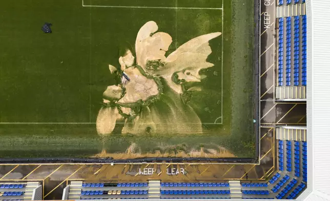 Am aerial view of a sinkhole on the pitch and flooded walkways at the Cherry Red Records Stadium, home of AFC Wimbledon in London, Monday, Sept. 23, 2024, after heavy rainfall. (Jordan Pettitt/PA via AP)