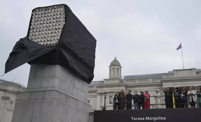 Mexican artist Teresa Margolles, fifth left, unveils her artwork "Mil Veces un Instante (A Thousand Times in an Instant)" on Fourth Plinth, marking 25 years of the ground-breaking commissioning programme for public art at Trafalgar Square, in London, Wednesday, Sept. 18, 2024. (AP Photo/Kin Cheung)