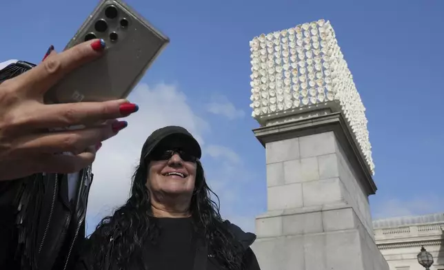 Mexican artist Teresa Margolles poses in front of her artwork "Mil Veces un Instante (A Thousand Times in an Instant)" for the Fourth Plinth, marking 25 years of the ground-breaking commissioning programme for public art at Trafalgar Square, in London, Wednesday, Sept. 18, 2024. (AP Photo/Kin Cheung)