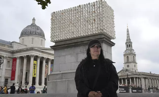 Mexican artist Teresa Margolles poses in front of her artwork "Mil Veces un Instante (A Thousand Times in an Instant)" for the Fourth Plinth, marking 25 years of the ground-breaking commissioning programme for public art at Trafalgar Square, in London, Wednesday, Sept. 18, 2024. (AP Photo/Kin Cheung)