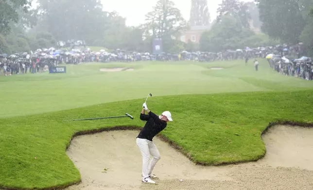 Northern Ireland's Rory McIlroy plays a shot from a bunker on the 3rd hole during day three of the PGA Championship at Wentworth Golf Club in Virginia Water, England, Saturday Sept. 21, 2024. (Zac Goodwin/PA via AP)