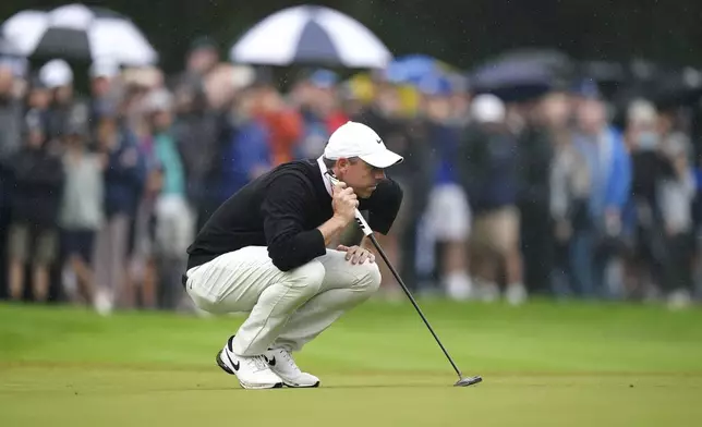 Northern Ireland's Rory McIlroy lines up a putt on the 4th green during day three of the PGA Championship at Wentworth Golf Club in Virginia Water, England, Saturday Sept. 21, 2024. (Zac Goodwin/PA via AP)