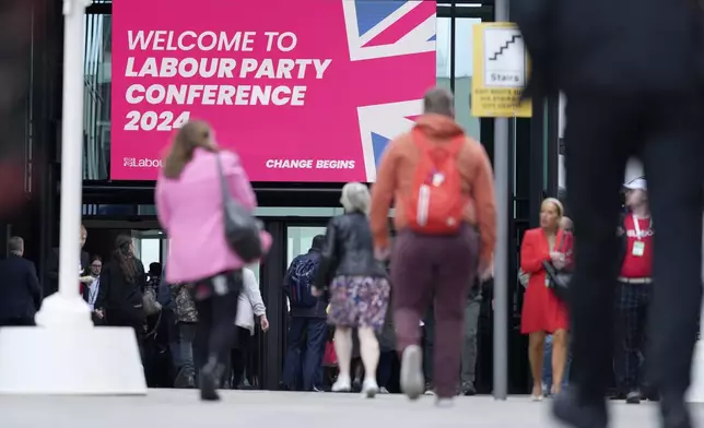 Members arrive to attend the Labour Party Conference in Liverpool, England, Tuesday, Sept. 24, 2024.(AP Photo/Jon Super)