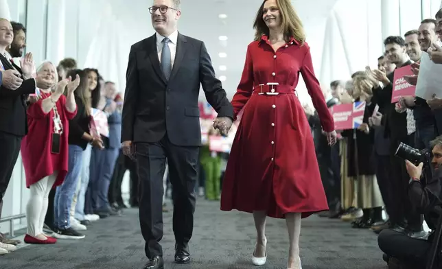 Britain's Prime Minister Keir Starmer and his wife, Victoria, arrive at the Labour Party Conference in Liverpool, England, Tuesday, Sept. 24, 2024.(AP Photo/Jon Super)