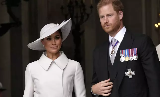 FILE - Prince Harry and Meghan Markle, Duke and Duchess of Sussex leave after a service of thanksgiving for the reign of Queen Elizabeth II at St Paul's Cathedral in London, Friday, June 3, 2022 on the second of four days of celebrations to mark the Platinum Jubilee. (AP Photo/Matt Dunham, Pool, File)