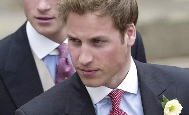 FILE - Britain's Prince William, right, and Prince Harry, left, after the marriage of their father Britain's Prince Charles, the Prince of Wales, and his wife Camilla, the Duchess of Cornwall, at the Guildhall in Windsor, England, after their civil wedding ceremony, on April 9, 2005. (AP Photo/Dave Caulkin, File)