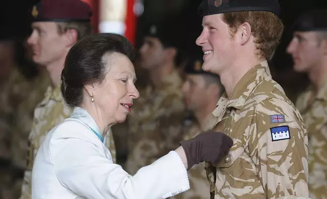 Britain's Princess Anne, left, presents Prince Harry with his campaign medal, in Windsor, England, Monday May 5, 2008. The 23-year-old Prince, known as Lieutenant Wales, is among around 160 members of the Household Cavalry who served in Afghanistan this winter to receive the decoration. (AP Photo/John Stillwell, pool)