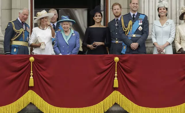 FILE - The royal family gather on the balcony of Buckingham Palace, with from left, Britain's Prince Charles, Camilla the Duchess of Cornwall, Prince Andrew, Queen Elizabeth II, Meghan the Duchess of Sussex, Prince Harry, Prince William and Kate the Duchess of Cambridge, as they watch a flypast of Royal Air Force aircraft pass over Buckingham Palace in London, Tuesday, July 10, 2018. (AP Photo/Matt Dunham, File)