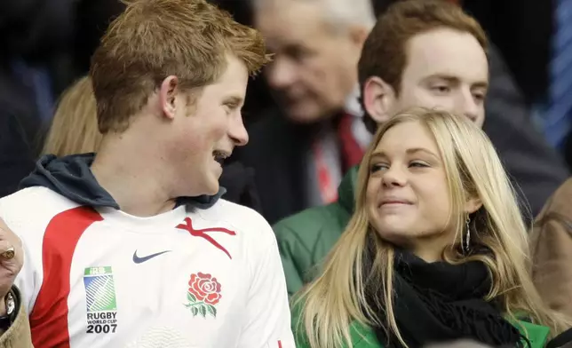 FILE - Britain's Prince Harry, left, talks to his girlfriend Chelsy Davy, who was born in Zimbabwe, before the international rugby match between England and South Africa at Twickenham stadium in west London, Saturday, Nov. 22, 2008. (AP Photo/Matt Dunham, File)