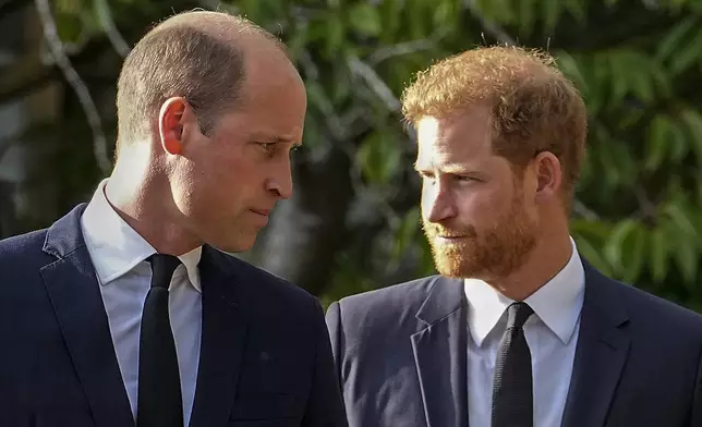 FILE - Britain's Prince William and Britain's Prince Harry walk beside each other after viewing the floral tributes for the late Queen Elizabeth II outside Windsor Castle, in Windsor, England on Sept. 10, 2022. (AP Photo/Martin Meissner, File)