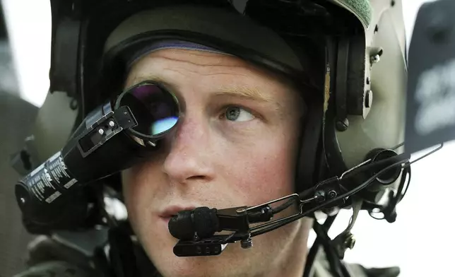 FILE - Britain's Prince Harry or just plain Captain Wales as he is known in the British Army, wears his monocle gun sight as he sits in the front seat of his cockpit at the British controlled flight-line in Camp Bastion southern Afghanistan, Dec. 12, 2012. (AP Photo/ John Stillwell, File)