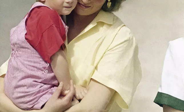 FILE - The Princess of Wales holds son Prince Harry while royal families posed for photographers at the Royal Palace, Mallorca, Spain, Aug. 9, 1987. (AP Photo/John Redman, File)