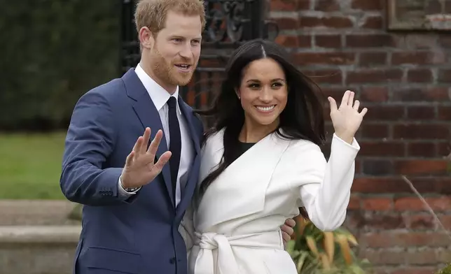 FILE - Britain's Prince Harry and his fiancee Meghan Markle pose for photographers during a photocall in the grounds of Kensington Palace in London, Monday Nov. 27, 2017. (AP Photo/Matt Dunham, File)