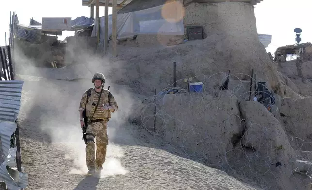 FILE - Britain's Prince Harry on patrol through the deserted town of Garmisir Jan. 2, 2008, close to FOB (forward operating base) Delhi, where he was posted in Helmand province Southern Afghanistan. (John Stillwell, Pool Photo via AP, File)