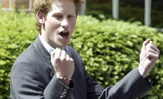 FILE - Britain's Prince Harry, 18, punches the air as he leaves Eton College on his last day at the top public school where he has been a pupil for five years, in Windsor, England, on June 12, 2003. (AP Photo/Dave Caulkin, File)