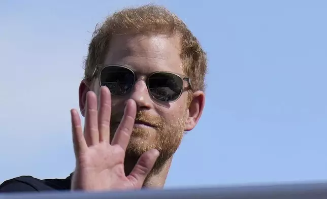 FILE - Britain's Prince Harry, the Duke of Sussex, waves during the Formula One U.S. Grand Prix auto race at Circuit of the Americas, on Oct. 22, 2023, in Austin, Texas. (AP Photo/Nick Didlick, File)