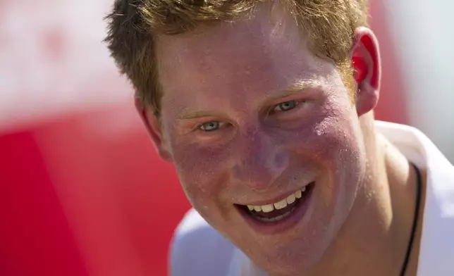 FILE - Britain's Prince Harry, smiles after playing rugby at Flamengo's beach in Rio de Janeiro, Brazil, Saturday March 10, 2012. (AP Photo/Felipe Dana, File)