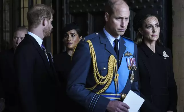 FILE - Britain's Prince William, second right, Kate, Princess of Wales, right, Prince Harry, left, and Meghan, Duchess of Sussex, second left, leave after they paid their respects to Queen Elizabeth II in Westminster Hall for the Lying-in State, in London, Wednesday, Sept. 14, 2022. (AP Photo/Emilio Morenatti, File)