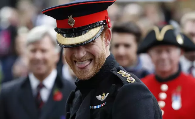 FILE - Britain's Prince Harry smiles as he speaks to veterans as he attends the official opening ceremony of The Field of Remembrance at Westminster Abbey in London, Thursday, Nov. 9, 2017. (AP Photo/Kirsty Wigglesworth, File)