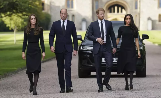 FILE - From left, Kate, the Princess of Wales, Prince William, Prince of Wales, Prince Harry and Meghan, Duchess of Sussex walk to meet members of the public at Windsor Castle, following the death of Queen Elizabeth II on Thursday, in Windsor, England, Saturday, Sept. 10, 2022. (Kirsty O'Connor/Pool Photo via AP, File)