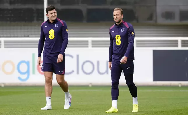 England's Harry Maguire, left, and Harry Kane, right, attend a training session of England's national soccer team in Burton upon Trent, England, Wednesday, Sept. 4, 2024. (Nick Potts/PA via AP)