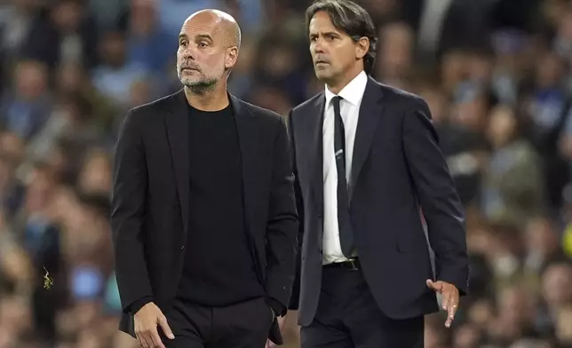 Manchester City manager Pep Guardiola, left, and Inter Milan manager Simone Inzaghi, right, during the Champions League opening phase soccer match between Manchester City and Inter Milan in Manchester, England, Wednesday, Sept. 18, 2024. (Martin Rickett/PA via AP)