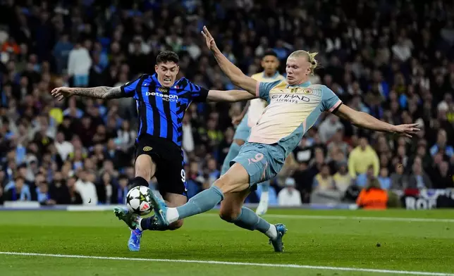 Manchester City's Erling Haaland, right, and Inter Milan's Alessandro Bastoni, left, challenge for the ball during the Champions League opening phase soccer match between Manchester City and Inter Milan in Manchester, England, Wednesday, Sept. 18, 2024. (Nick Potts/PA via AP)