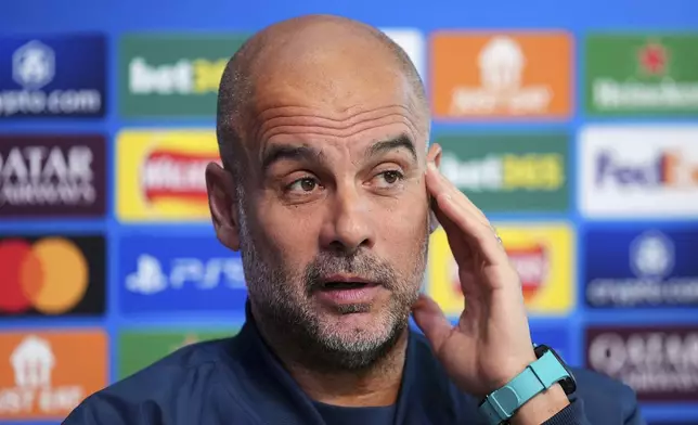 Manchester City manager Pep Guardiola attends a press conference at the City Football Academy in Manchester, England, Tuesday Sept. 17, 2024. (Martin Rickett/PA via AP)