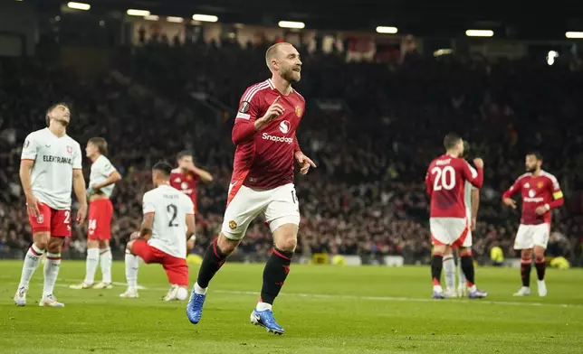 Manchester United's Christian Eriksen celebrates after scoring the opening goal during the Europa League opening phase soccer match between Manchester United and Twente in Manchester, England, Wednesday, Sept. 25, 2024. (AP Photo/Dave Thompson)
