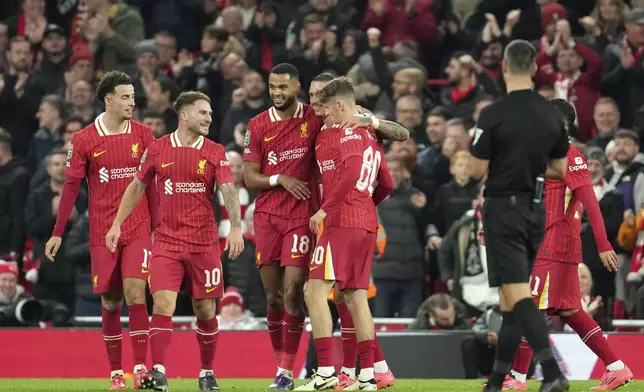 Liverpool's Cody Gakpo, 3rd left, celebrates after scoring his side's fifth goal during the English League Cup soccer match between Liverpool and West Ham United at Anfield Stadium, Liverpool, England, Wednesday, Sept. 25, 2024. (AP Photo/Jon Super)