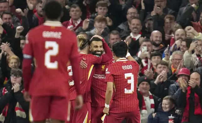 Liverpool's Mohamed Salah, center, celebrates after scoring his side's third goal during the English League Cup soccer match between Liverpool and West Ham United at Anfield Stadium, Liverpool, England, Wednesday, Sept. 25, 2024. (AP Photo/Jon Super)